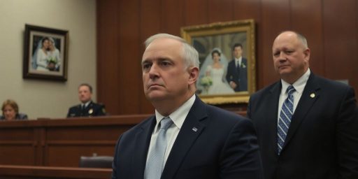 Courtroom setting with anxious man and wedding photo.